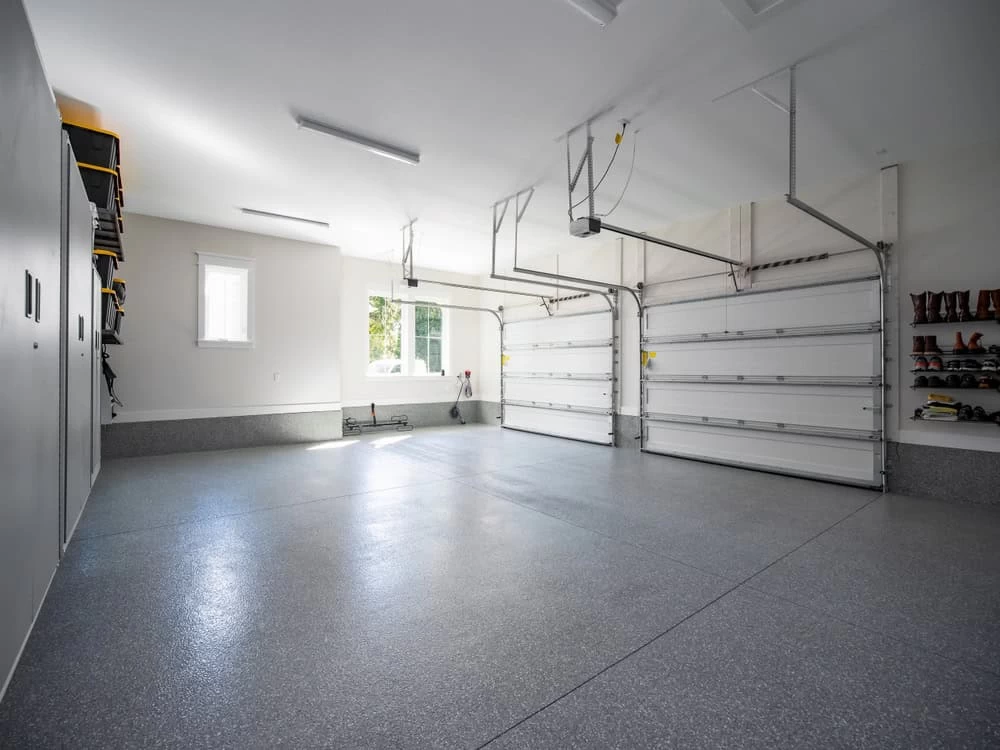 A garage with two doors and a garage door opener.