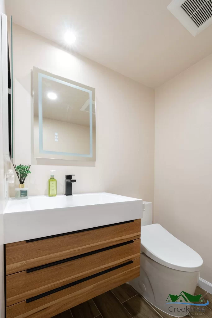 A shower with a glass door and shelves.