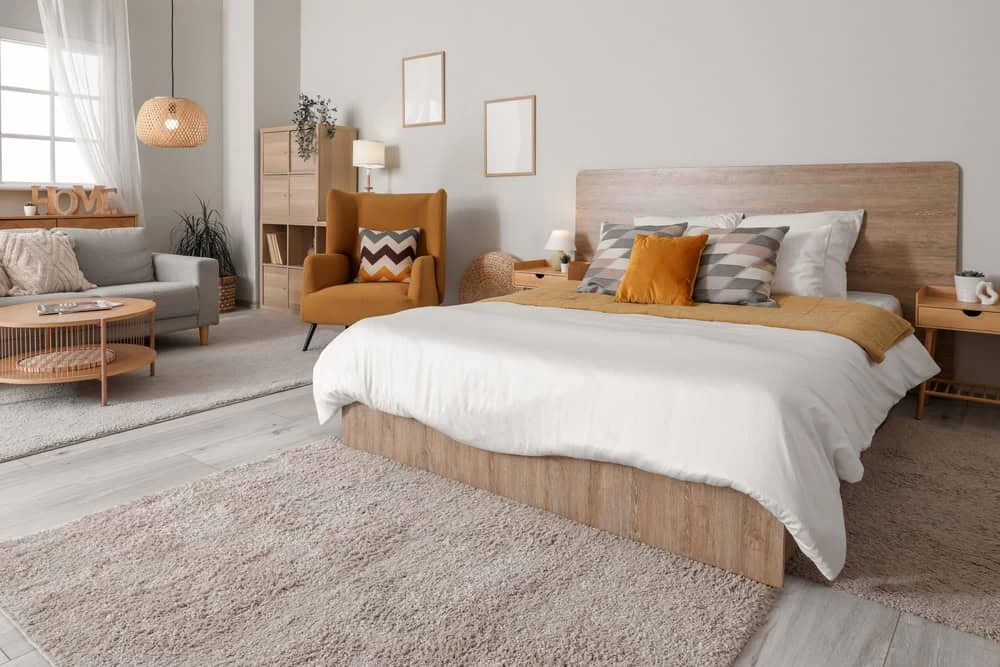 A modern bedroom with a bed, chair and table.